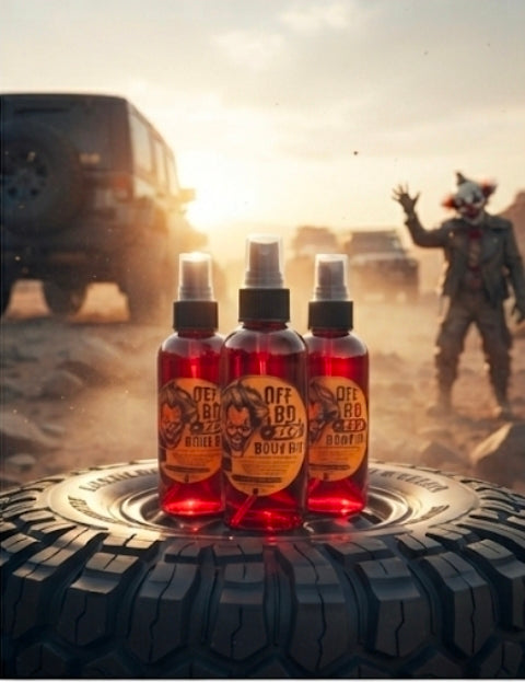 The Riot Act Off-Road Red Body Oil Skin Oil bottles displayed on a rugged tire in an outdoor setting.